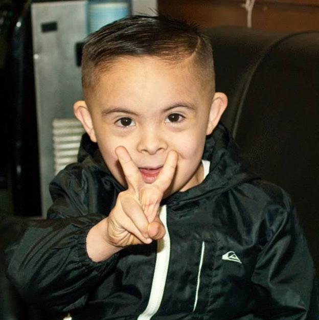 kid throwing up a peace sign
