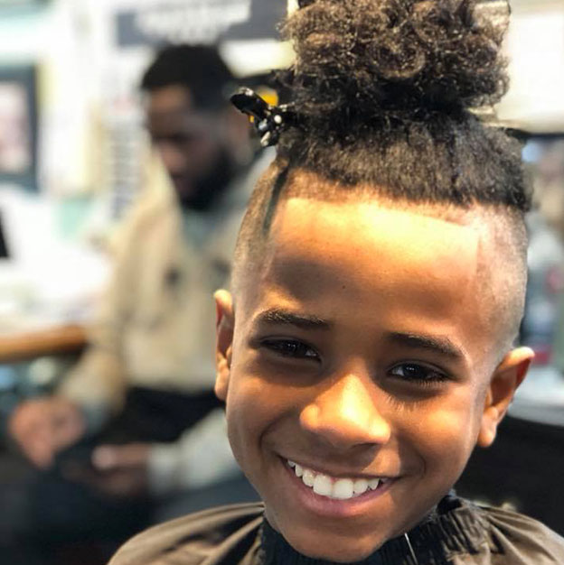 Kid smiling after his haircut